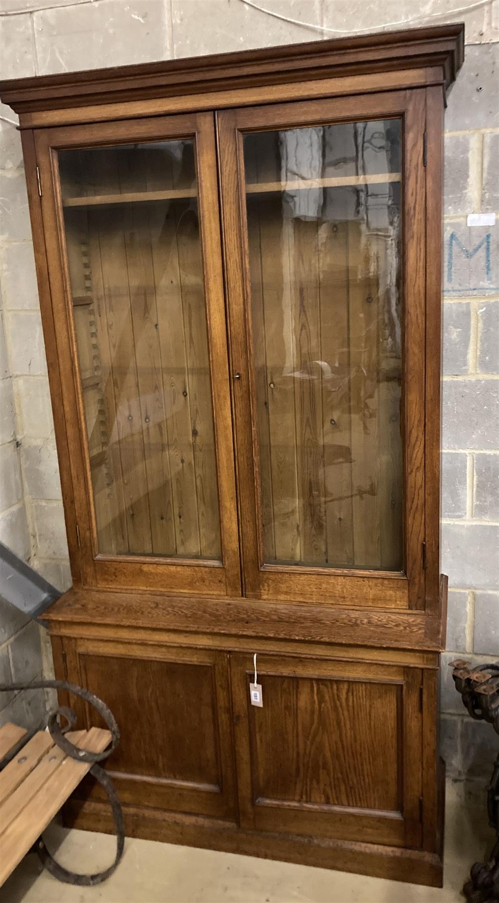 A late 19th century panelled oak library bookcase, length 118cm, depth 47cm, height 223cm